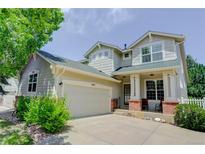 Charming two-story home with attached two car garage and inviting front porch at 2608 S Troy Ct, Aurora, CO 80014