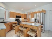 Bright kitchen with ample cabinet space, stainless steel appliances and a functional island at 2608 S Troy Ct, Aurora, CO 80014