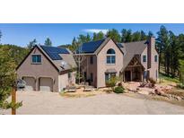Charming home with a two-car garage and solar panels on the roof situated in a serene and picturesque landscape at 1057 Reed Ranch Rd, Boulder, CO 80302