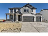 Charming two-story home with gray trim, multi-car garage and a welcoming covered front porch at 39896 Floyd St, Elizabeth, CO 80107