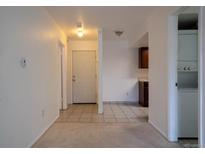 Inviting entryway with tile flooring leading into a bright and open floor plan, complete with kitchen access at 8330 Zuni St # 214, Denver, CO 80221