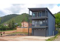 Modern two-story home with sleek balconies, gray exterior, and mountain views at 260 Upper Glenway Rd, Palmer Lake, CO 80133