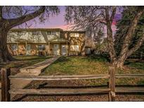 Charming townhome featuring brick and siding with a well-maintained front yard and a cozy, covered porch at 4509 Everett St, Wheat Ridge, CO 80033