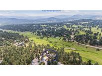 Beautiful aerial view of the property backing to HOA open space and trail at 2023 Mammoth Ct, Evergreen, CO 80439