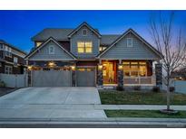 Charming two-story home with a three-car garage, stone accents, and a landscaped front yard at 336 Painted Horse Way, Erie, CO 80516