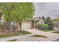 Charming single-Gathering home featuring stone accents, a well-manicured lawn, and a two-car garage in a desirable neighborhood at 17484 E 99Th Ave, Commerce City, CO 80022