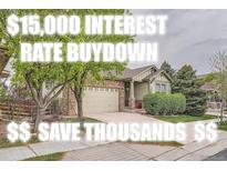 Charming single-Gathering home boasts a well-maintained lawn and an inviting facade with stone and siding accents at 17484 E 99Th Ave, Commerce City, CO 80022