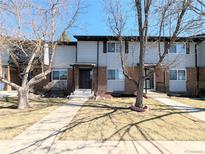 Inviting townhome exterior with brick accents, tidy lawn, and a walkway to the front door at 3061 W 92Nd Ave # 2D, Westminster, CO 80031