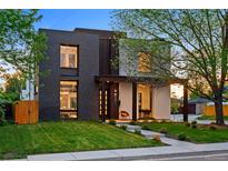 Striking modern two-story home with dark brick and light stucco, accented by lush green lawn and mature trees at 1601 S Columbine St, Denver, CO 80210