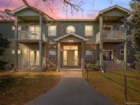 Charming two-story condo with balconies, brick accents, and well-maintained lawn at 5335 Pecos Way # 4, Denver, CO 80221