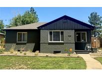 Charming front exterior of a brick home featuring manicured lawn, modern windows and inviting entry at 1560 Quince St, Denver, CO 80220