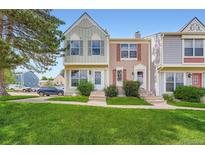 Charming townhomes feature a well-maintained lawn, beautiful landscaping, and a serene neighborhood at 9202 W Ontario Dr, Littleton, CO 80128