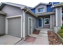 Charming home exterior featuring a well-maintained garage and inviting front door at 11009 Gaylord. St, Northglenn, CO 80233