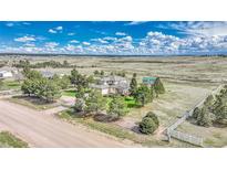 Expansive home on a lush lot, with mature trees and a stunning view of the surrounding countryside at 2188 Savage Rd, Elizabeth, CO 80107