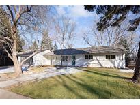 Charming renovated home with a well-manicured lawn and mature trees creating an inviting curb appeal at 2718 S Langley Ct, Denver, CO 80210