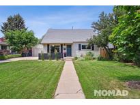 Charming home with a well-maintained front yard, inviting walkway, and lovely curb appeal at 2965 S Gilpin St, Denver, CO 80210