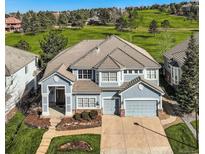 Beautiful two-story home featuring a three-car garage and professionally landscaped yard on a manicured green space at 10040 Longview Dr, Lone Tree, CO 80124