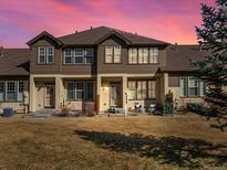 Charming multi-story home featuring a well-maintained lawn and a welcoming front entrance with chairs at 5833 S Van Gordon Ln, Littleton, CO 80127