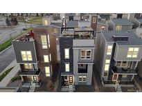 Modern townhomes showcasing varied architectural details and rooftop terraces in a vibrant community setting at 11916 Peakview Ln, Broomfield, CO 80021