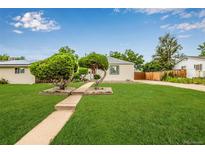 Charming single story home with manicured lawn and unique ornamental trees at 1601 S Yates St, Denver, CO 80219