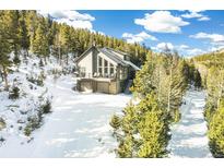 Beautiful mountain home featuring a large deck and an attached two-car garage at 1758 Sinton Rd, Evergreen, CO 80439