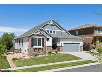 Beautiful home with stone and siding exterior, two-car garage, and landscaped front yard at 12189 Windy Trail Ln, Parker, CO 80138