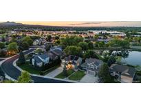 Gorgeous aerial view of a residential neighborhood with well-maintained homes and tree-lined streets near a pond at 6266 Holman St, Arvada, CO 80004