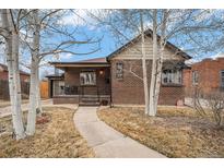 Charming brick home with a cozy front porch and well-maintained landscaping at 1363 Stuart St, Denver, CO 80204