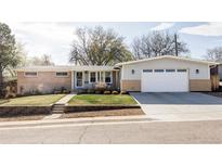 Charming single-story home with brick accents, well-maintained lawn, and an attached two-car garage at 375 Coral St, Broomfield, CO 80020
