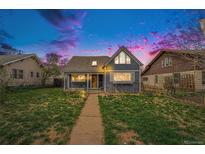 Charming home featuring a well-kept lawn, inviting pathway and a cozy covered front porch at 3921 S Acoma St, Englewood, CO 80110