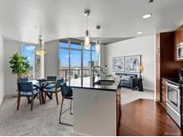 Bright living space with modern furnishings, an island and expansive windows with city views at 891 14Th St # 3204, Denver, CO 80202