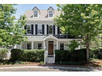 Charming two-story home with black shutters, dormers, and mature landscaping at 8739 E 23Rd Ave, Denver, CO 80238