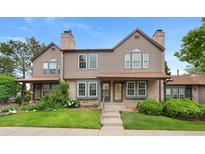 Charming townhome with brick and siding exterior, well-manicured lawn, and inviting entrance at 17151 E Stanford Ave # B, Aurora, CO 80015