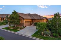 Charming single-Gathering home featuring a concrete driveway, an attached garage and mature trees at 4336 Chateau Ridge Rd, Castle Rock, CO 80108