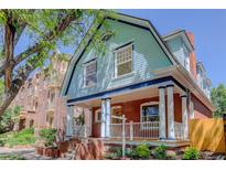 Charming two-story home featuring a brick facade, inviting front porch, and architectural details at 729 E 10Th Ave, Denver, CO 80203