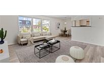 Bright living room with large windows, stylish furniture, and an open floor plan at 9100 E Girard Ave # 7, Denver, CO 80231