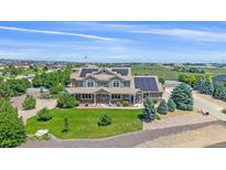Beautiful two-story home with a well-manicured lawn and solar panels at 8655 E 130Th Ave, Thornton, CO 80602