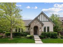 Charming single-Gathering home with stone accents, manicured lawn, and lush landscaping creating excellent curb appeal at 652 Ulster Way, Denver, CO 80230