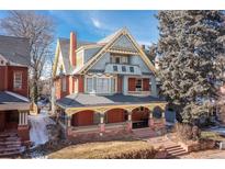 Beautiful exterior view of a charming multi-story home with a lovely porch and classic architectural details at 1435 Vine St # 2, Denver, CO 80206