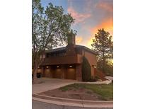 Stunning exterior view of a two-story house with a brick facade and lush green trees at 5555 E Briarwood Ave # 706, Centennial, CO 80122