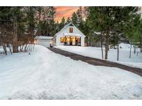 Charming Craftsman home with snowy front yard and attached garage at 950 Tenderfoot Dr, Larkspur, CO 80118