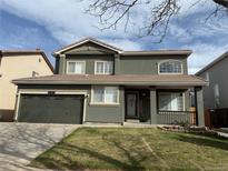 Charming two-story home featuring an attached two-car garage and well-maintained lawn at 19731 E 40Th Ave, Denver, CO 80249