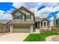 Charming two-story home featuring an attached two-car garage and well-maintained lawn at 863 Homestead Dr, Highlands Ranch, CO 80126
