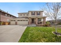 Beautiful two-story home with a three-car garage, manicured lawn and lovely landscaping at 17124 Mariposa St, Broomfield, CO 80023