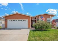Charming single-Gathering home with a two-car garage, manicured lawn, and mature landscaping at 7930 Larkspur Cir, Frederick, CO 80530
