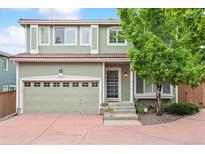 Charming two-story home featuring a well-maintained lawn, attached two car garage and inviting front porch at 1449 Braewood Ave, Highlands Ranch, CO 80129