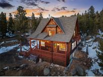 Charming cabin-style home with a spacious wrap-around deck, nestled amongst the trees with beautiful sunset views at 439 Ronnie Rd, Golden, CO 80403