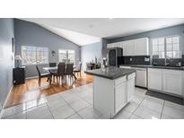 Modern kitchen with granite countertops, white cabinetry and stainless-steel appliances at 5229 Nighthawk Pkwy, Brighton, CO 80601