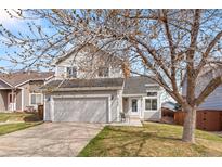 Charming two-story home featuring a two-car garage, landscaped yard, and inviting front porch at 4785 Aberdeen Ave, Highlands Ranch, CO 80126