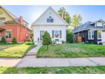 Charming home featuring a well-manicured front lawn, quaint architecture, and lovely curb appeal at 1006 S Emerson St, Denver, CO 80209